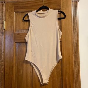 Cream colored body suit.